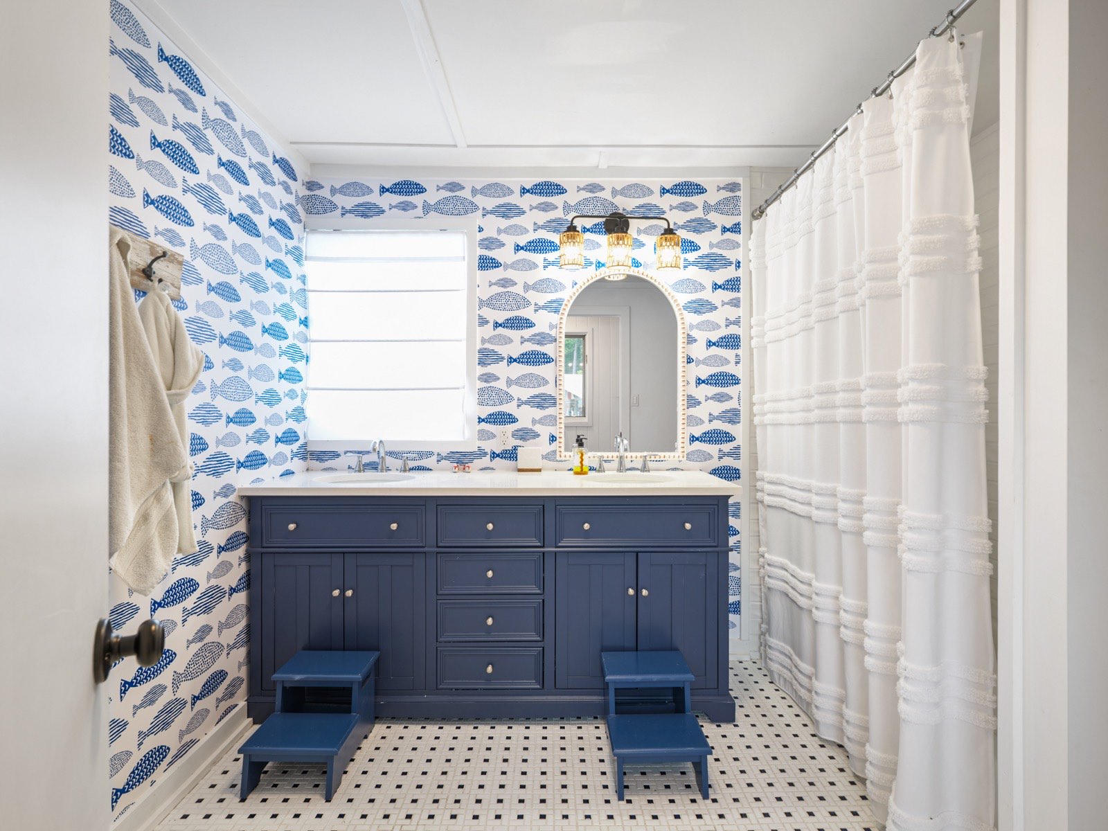 Coastal bathroom remodel with navy vanity