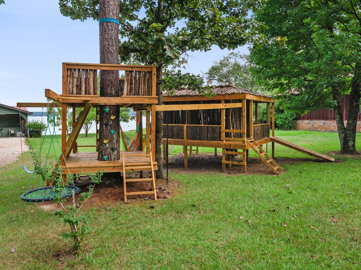 Custom wooden play structure built around existing trees