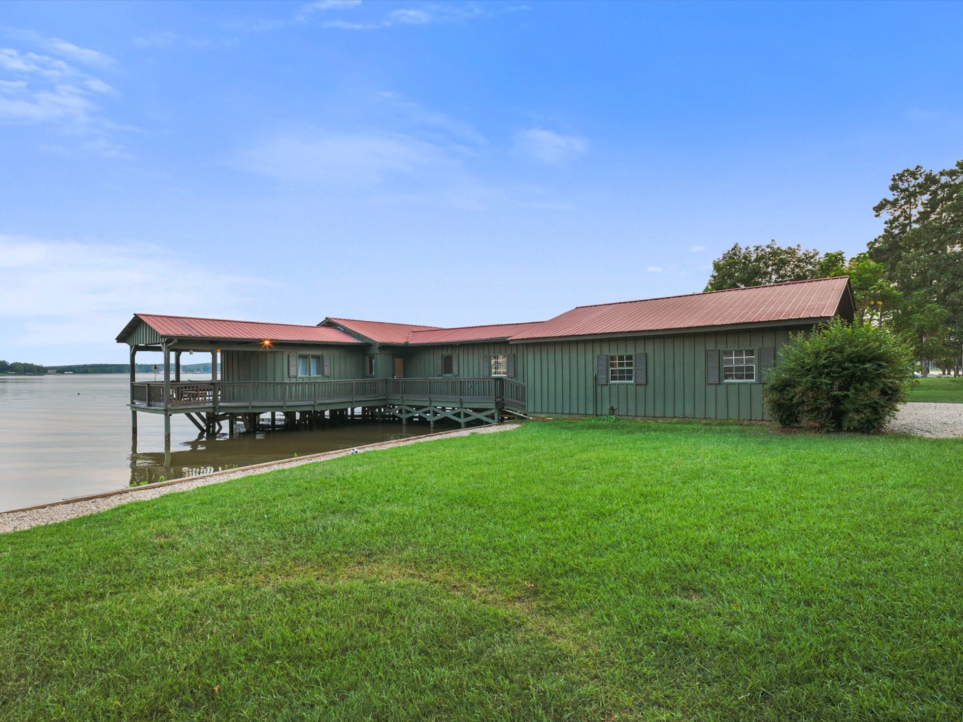 Sage-green waterfront building on pilings